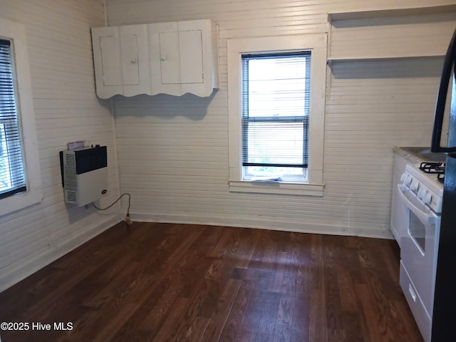 kitchen featuring heating unit, white cabinetry, dark hardwood / wood-style flooring, and white gas stove