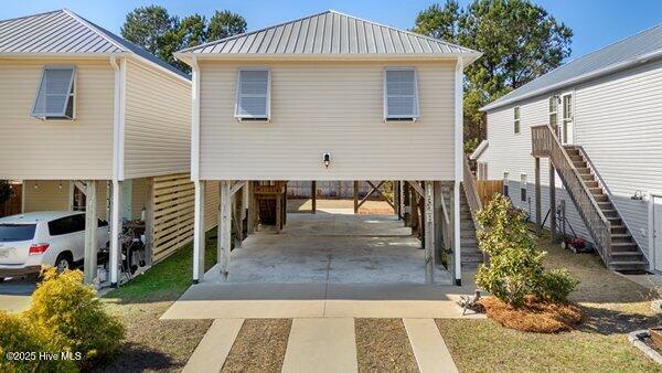 back of property featuring a carport