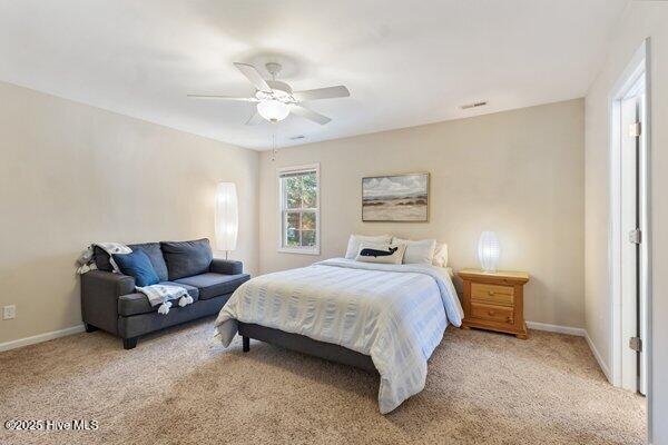 bedroom featuring light carpet and ceiling fan