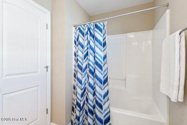 bathroom featuring shower / bath combination with curtain