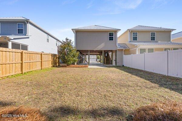 rear view of house featuring a yard