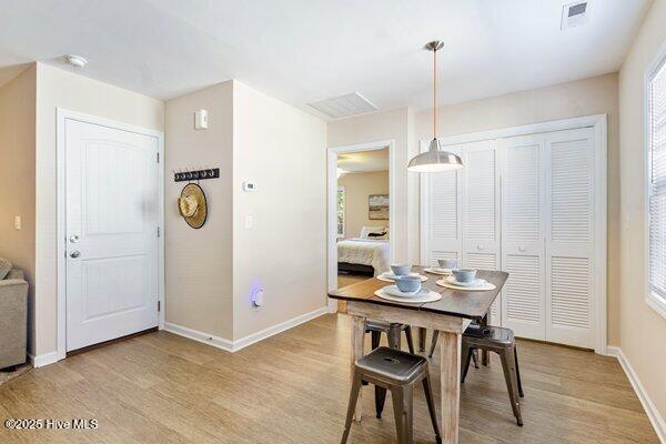 dining area featuring light hardwood / wood-style flooring and a healthy amount of sunlight