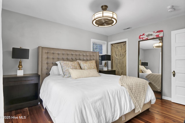 bedroom featuring dark wood-type flooring and a closet