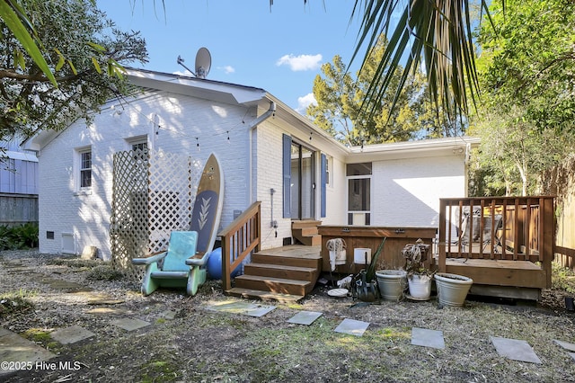 back of house featuring a deck