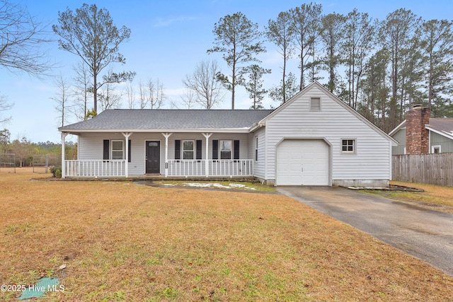 ranch-style home featuring a garage, a front yard, and covered porch