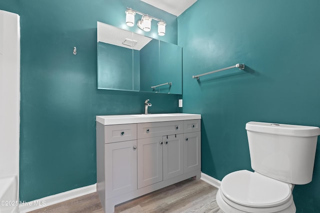 bathroom featuring vanity, hardwood / wood-style floors, and toilet