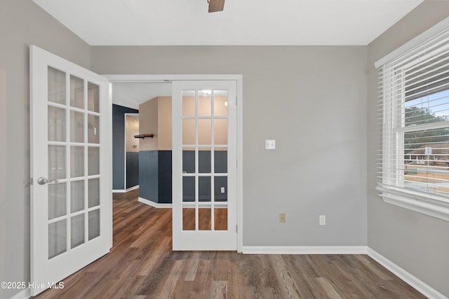 unfurnished room with french doors and dark wood-type flooring