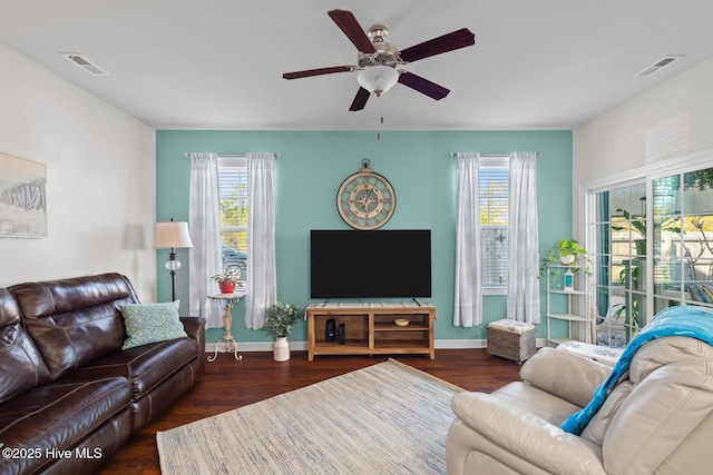 living room with ceiling fan, a healthy amount of sunlight, and dark hardwood / wood-style floors