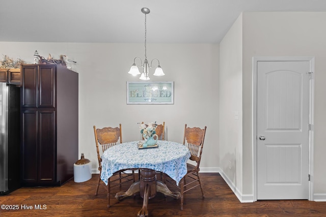 dining room featuring dark wood-type flooring and a notable chandelier