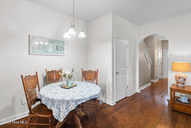 dining area featuring a chandelier and dark hardwood / wood-style flooring