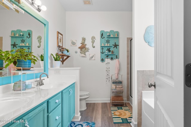 full bathroom featuring vanity, toilet, hardwood / wood-style floors, and shower with separate bathtub