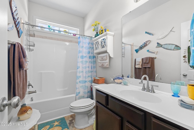 full bathroom featuring shower / bath combo, vanity, and toilet