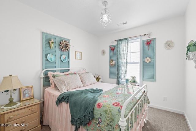 bedroom with a chandelier and carpet floors