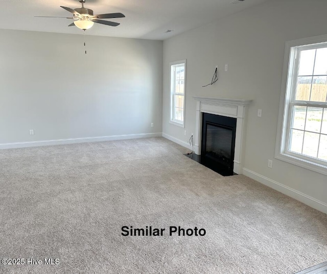 unfurnished living room featuring ceiling fan and light carpet