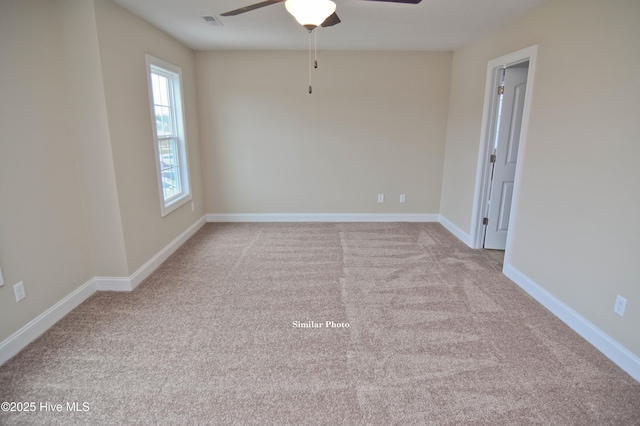 unfurnished room with ceiling fan and light carpet