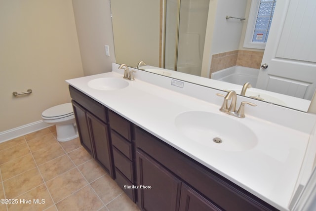 bathroom with vanity, tile patterned floors, toilet, and a bathing tub