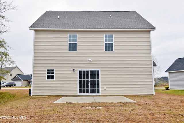 rear view of house featuring a yard and a patio