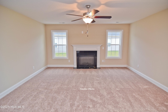 unfurnished living room featuring light colored carpet and ceiling fan