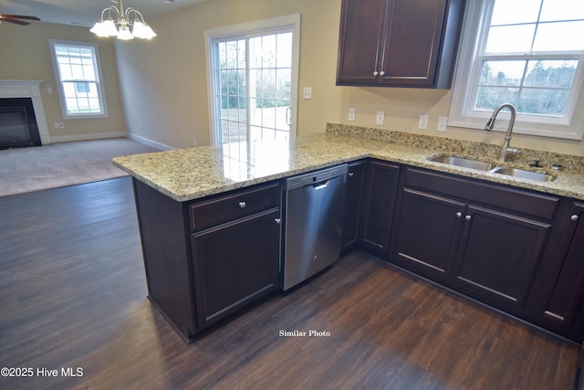 kitchen featuring sink, hanging light fixtures, stainless steel dishwasher, and kitchen peninsula