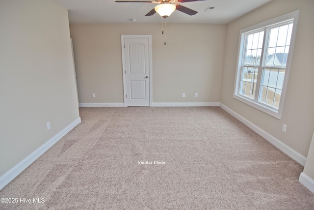 empty room featuring light carpet and ceiling fan