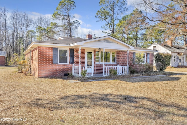 ranch-style home with a front yard and a porch