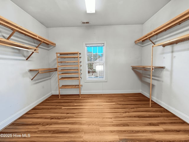 spacious closet with hardwood / wood-style floors