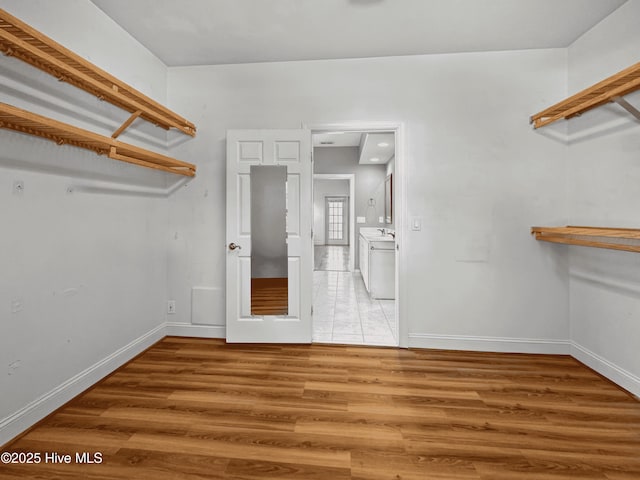 spacious closet with wood-type flooring and washer / dryer