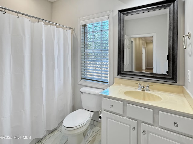 bathroom with vanity, tile patterned flooring, and toilet