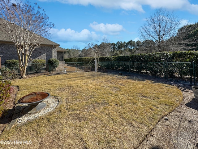 view of yard featuring an outdoor fire pit