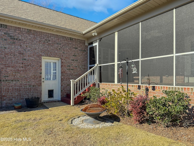 property entrance featuring a lawn