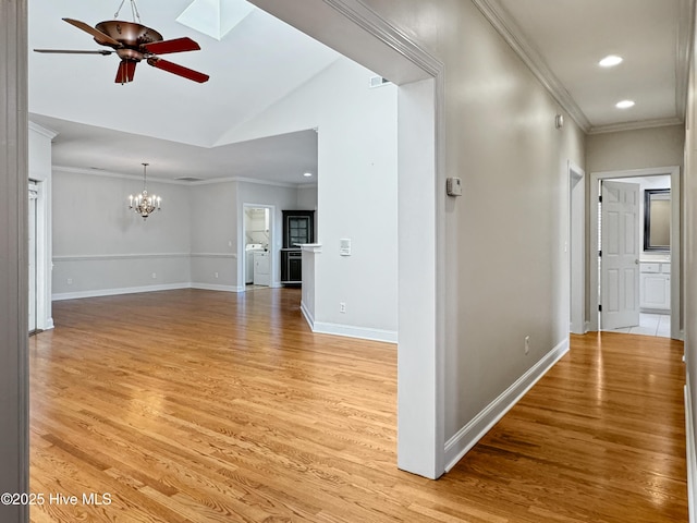 interior space with lofted ceiling, ceiling fan with notable chandelier, ornamental molding, and light hardwood / wood-style floors