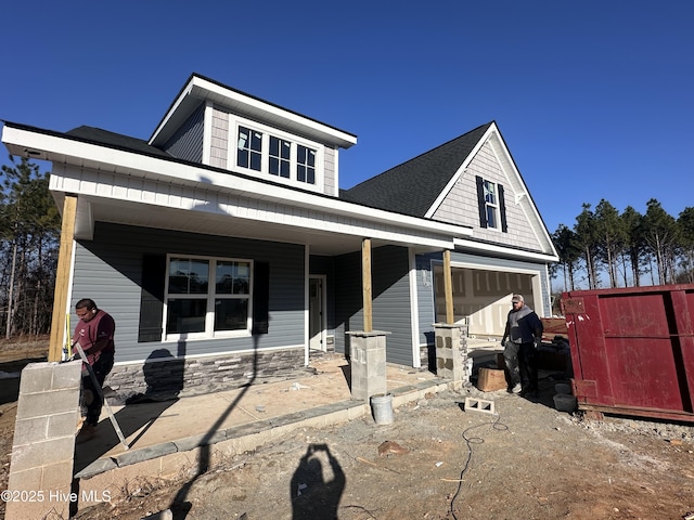 view of front of house with a garage and a porch