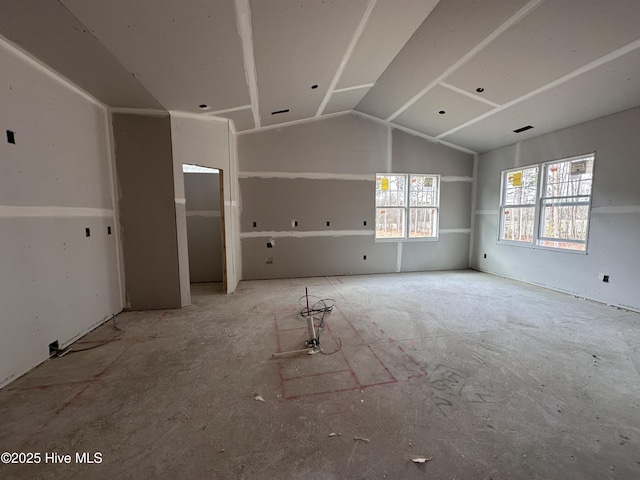 unfurnished living room featuring lofted ceiling