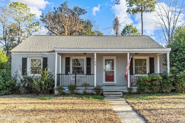 view of front facade featuring covered porch and a front lawn