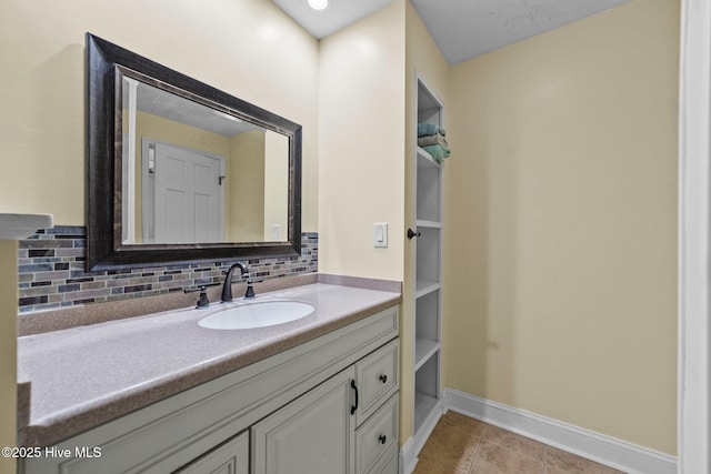 bathroom with tasteful backsplash, vanity, and tile patterned floors