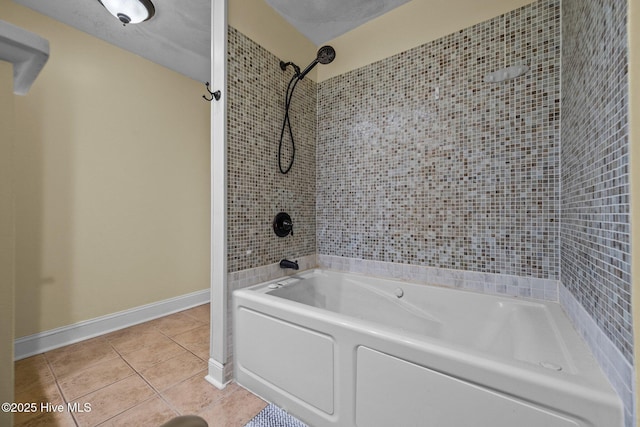 bathroom featuring tile patterned flooring, tiled shower / bath combo, and a textured ceiling