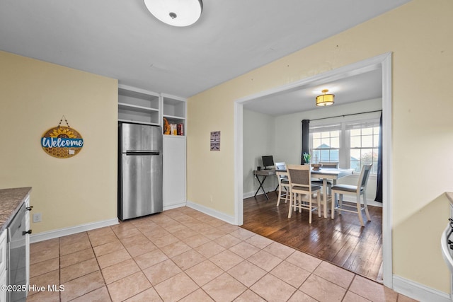 kitchen featuring stainless steel appliances and light tile patterned floors