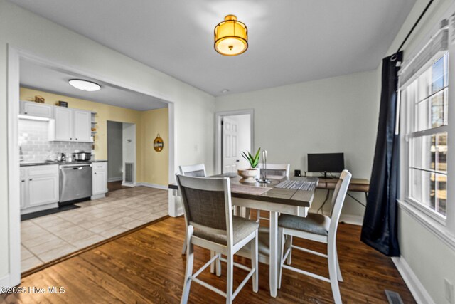 dining area featuring wood-type flooring