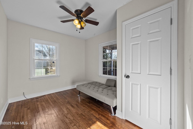 unfurnished room with ceiling fan, plenty of natural light, and dark hardwood / wood-style flooring