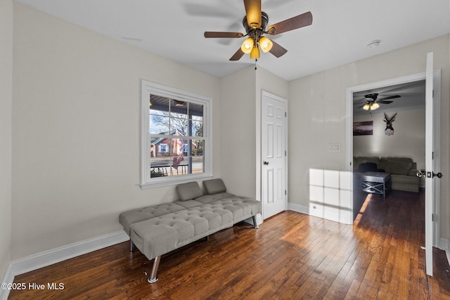 sitting room with dark wood-type flooring