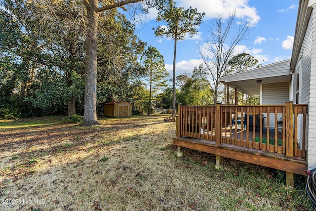 view of yard featuring a storage unit and a deck