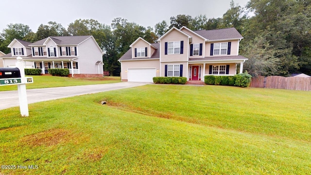 colonial home featuring a garage and a front yard