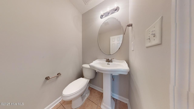 bathroom with tile patterned floors and toilet