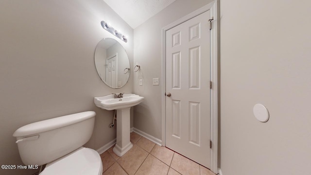 bathroom featuring toilet and tile patterned flooring