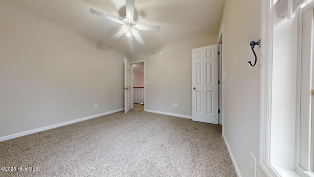 unfurnished bedroom featuring ceiling fan and carpet flooring