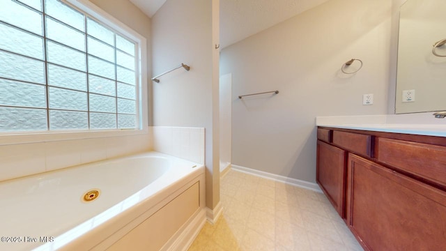 bathroom featuring vanity and a bath