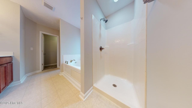 bathroom featuring vanity and shower with separate bathtub