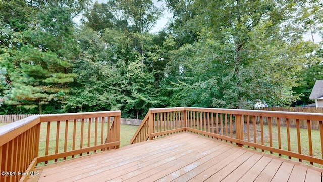 wooden deck featuring a yard