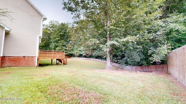 view of yard with a wooden deck