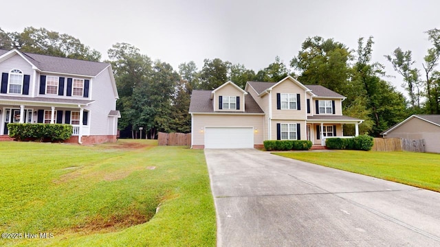 colonial house featuring a garage, a porch, and a front yard